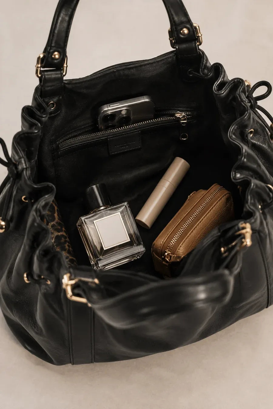 Inside the Quievera bag: zip pocket, perfume, lipstick and a pouch